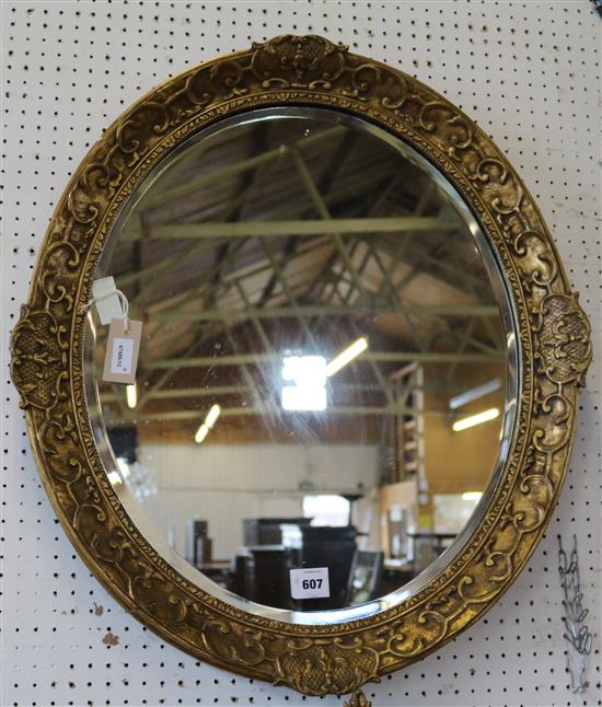 Oval gilt-framed wall mirror